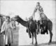 Syria: Bedouin woman riding a camel led by her husband, c.1905